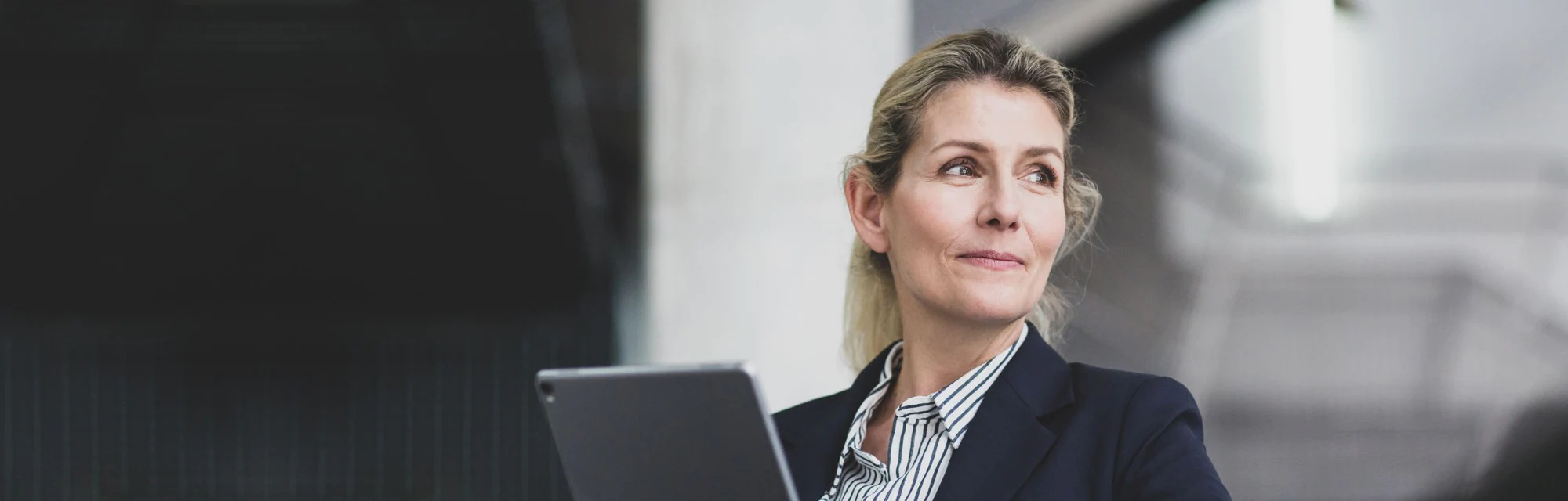 Woman using her tablet to sign on to  New Estonia Trust SmartBanking for Business